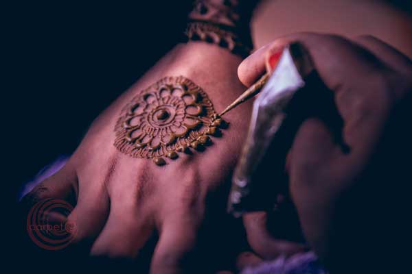 mehndi artist at work for the bride 